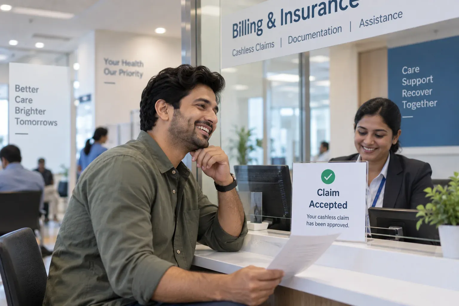 A customer smiling at the billing and insurance desk after his cashless claim is accepted